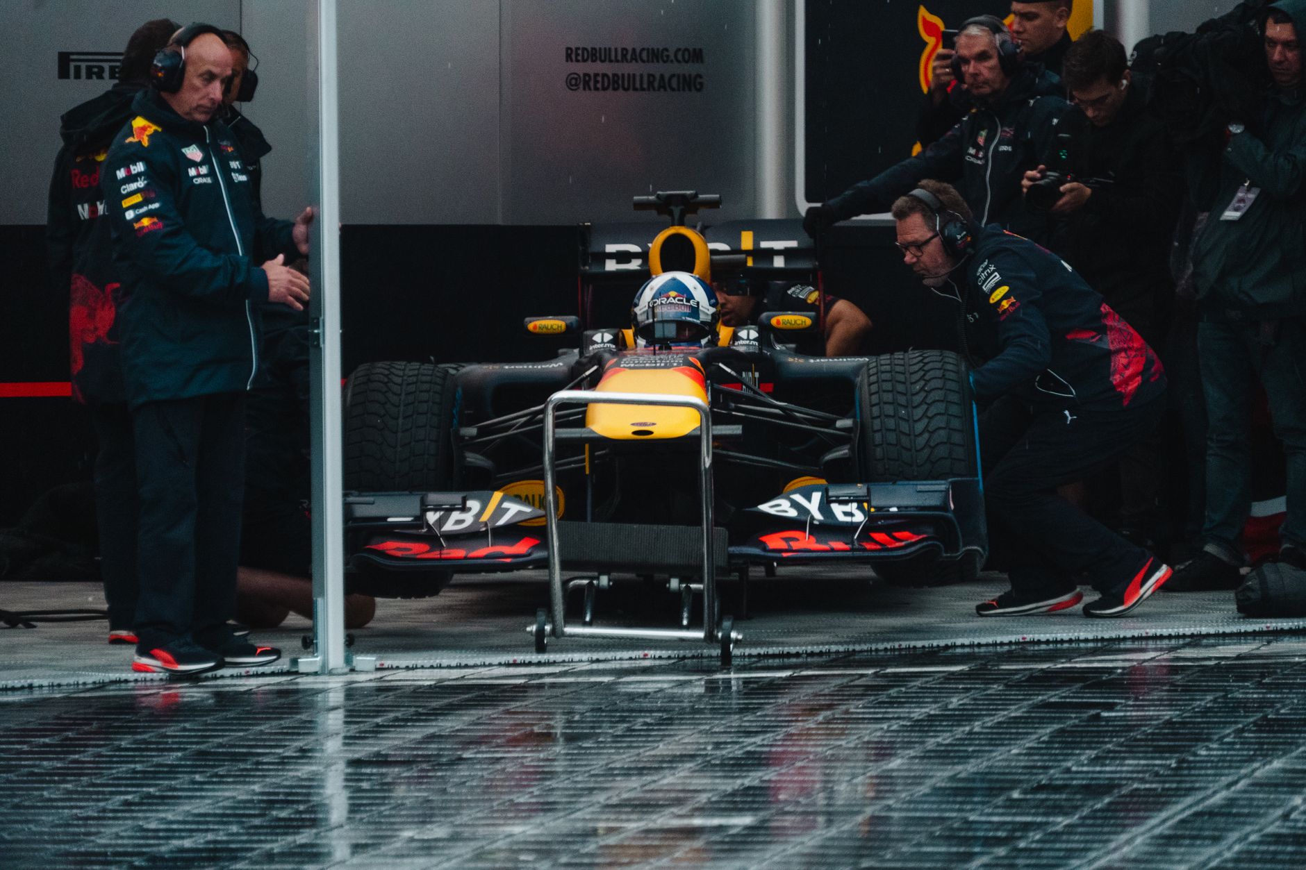 A pit crew working on a race car during a stop