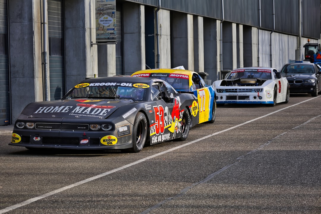 Race cars lined up on an asphalt oval